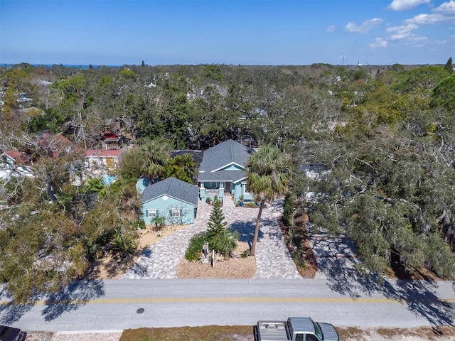 birds eye view of property featuring a view of trees