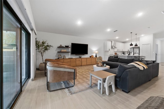 living room featuring recessed lighting and visible vents