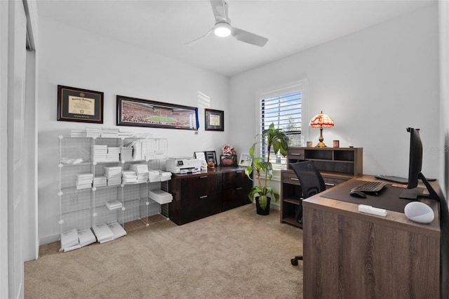 office with a ceiling fan and light colored carpet