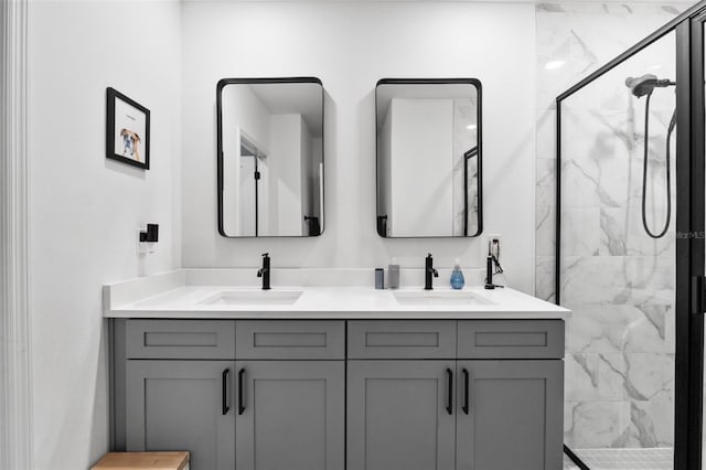 bathroom featuring double vanity, a sink, and a marble finish shower