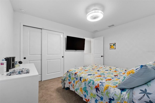 bedroom featuring a closet, visible vents, and light carpet