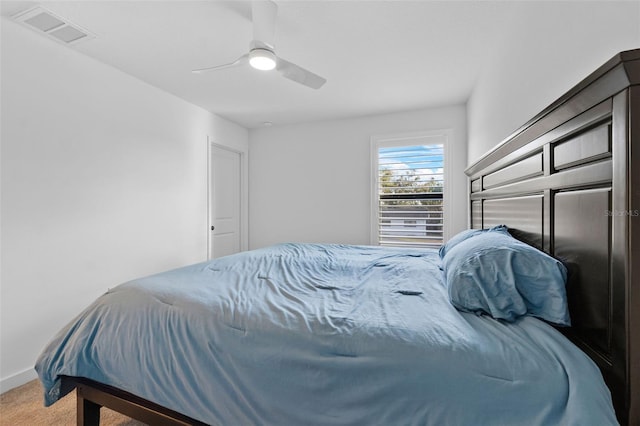 carpeted bedroom featuring ceiling fan, visible vents, and baseboards