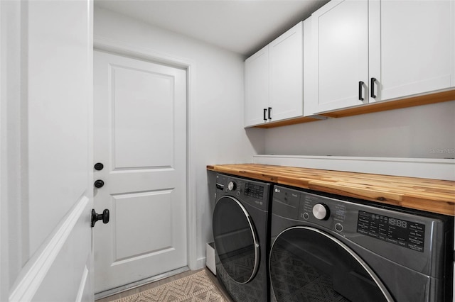 laundry room featuring cabinet space and washing machine and clothes dryer