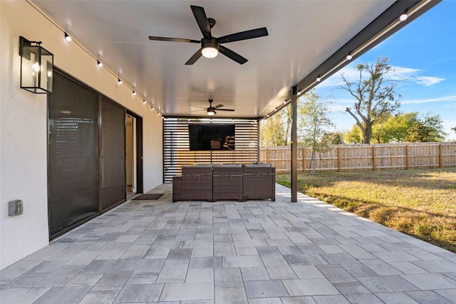 view of patio / terrace with an outdoor hangout area, fence, and a ceiling fan