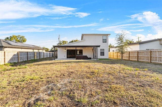 back of property with a patio, a lawn, a fenced backyard, and stucco siding