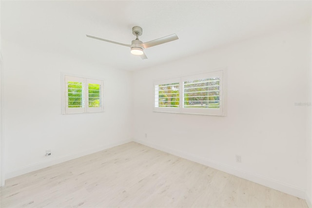 unfurnished room featuring a ceiling fan, baseboards, and wood finished floors