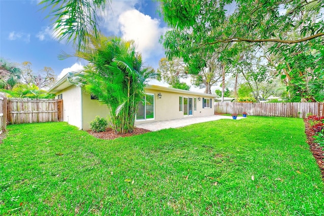 view of yard with a fenced backyard and a patio