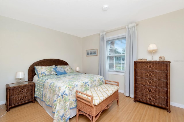 bedroom with light wood-style flooring and baseboards