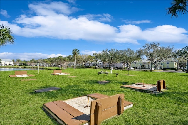 view of property's community featuring a yard and a water view