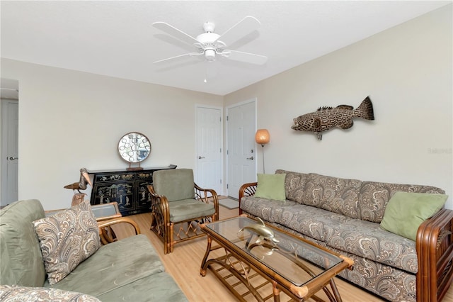 living room with light wood-style flooring and a ceiling fan