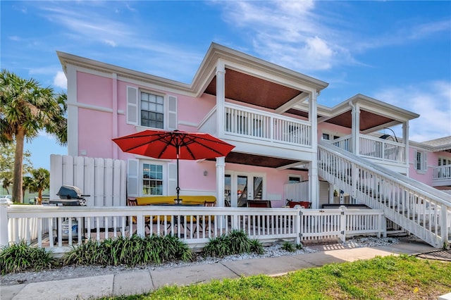 view of front of house featuring stairway and stucco siding