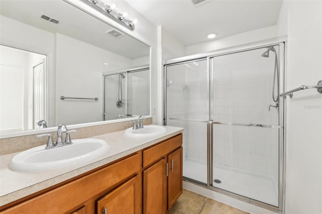 full bath with a stall shower, a sink, and visible vents