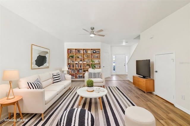 living room with light wood-type flooring and ceiling fan