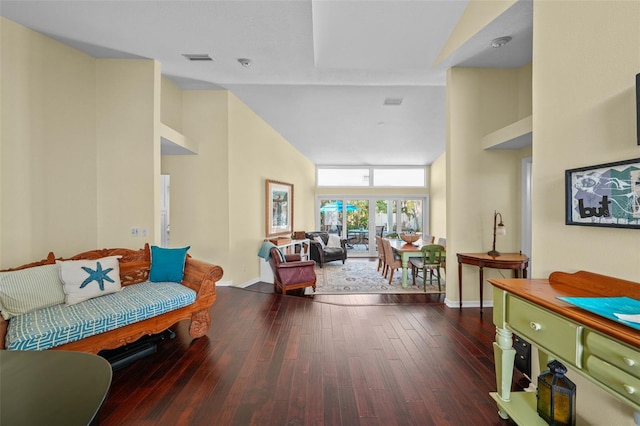 interior space with high vaulted ceiling, visible vents, baseboards, and wood finished floors