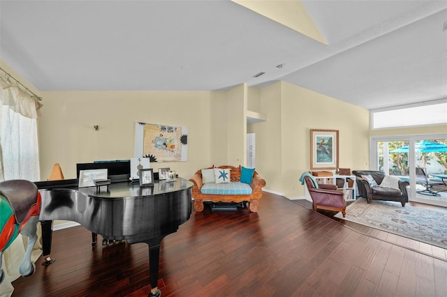 interior space featuring baseboards, high vaulted ceiling, and wood finished floors