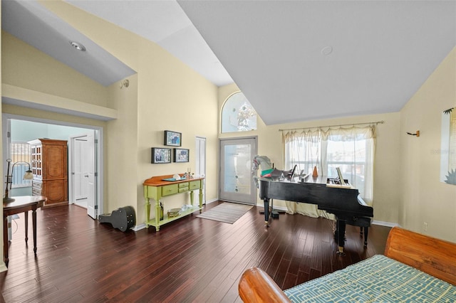 entryway with high vaulted ceiling, baseboards, and wood finished floors