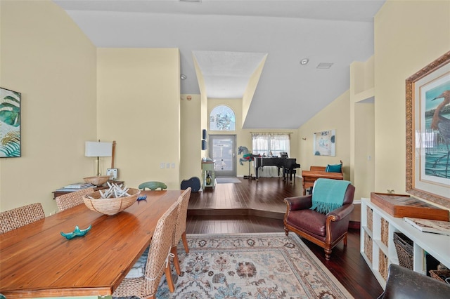 office space with visible vents, vaulted ceiling, and hardwood / wood-style floors