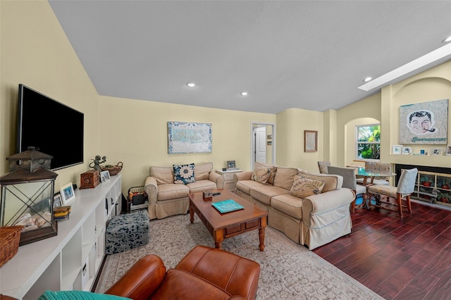 living area featuring lofted ceiling with skylight, wood finished floors, and recessed lighting