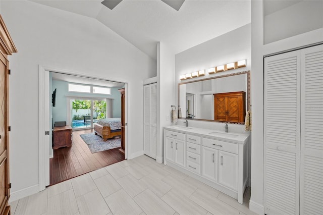 full bathroom with double vanity, a closet, and a sink