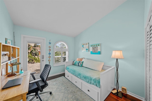 bedroom with access to outside, baseboards, vaulted ceiling, and wood finished floors