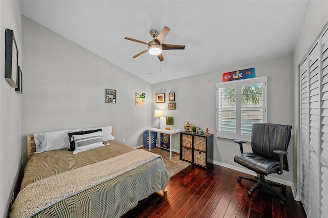 bedroom featuring lofted ceiling, hardwood / wood-style flooring, baseboards, and a ceiling fan