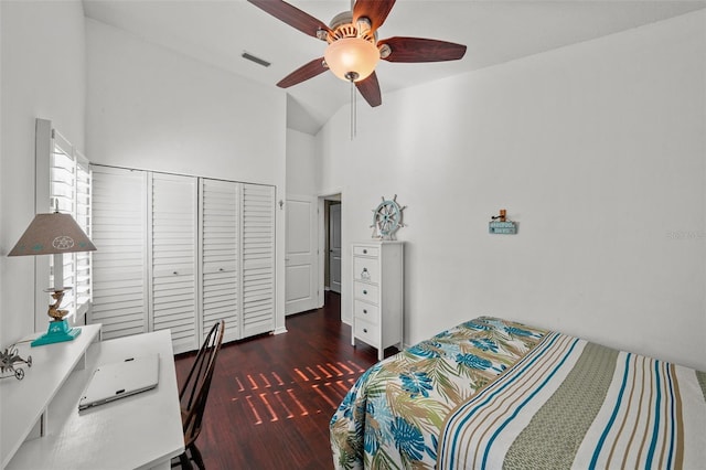 bedroom with high vaulted ceiling, wood finished floors, visible vents, a ceiling fan, and a closet