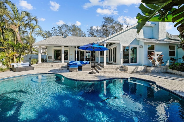 view of pool featuring a fenced in pool, a patio area, and an outdoor hangout area