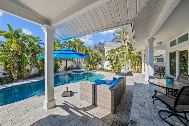 view of pool with a pool with connected hot tub and a patio area