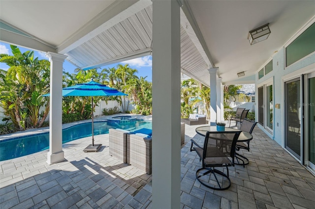 view of patio / terrace featuring a pool with connected hot tub