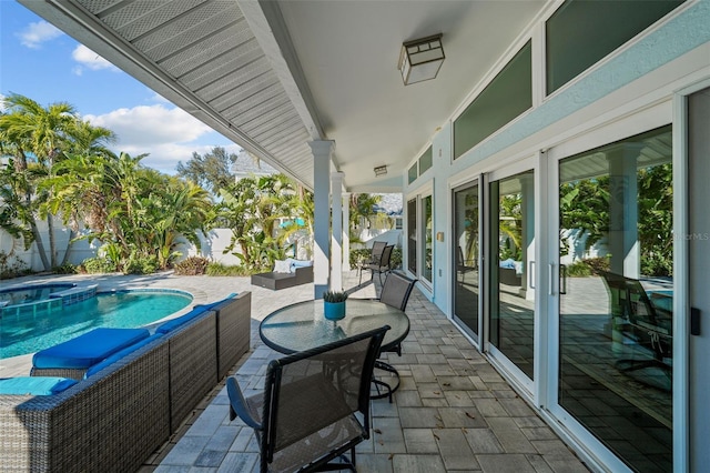 view of patio featuring outdoor dining space and a pool with connected hot tub