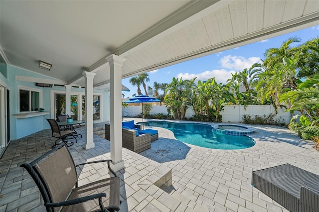 view of swimming pool with a patio area, a fenced backyard, and a pool with connected hot tub