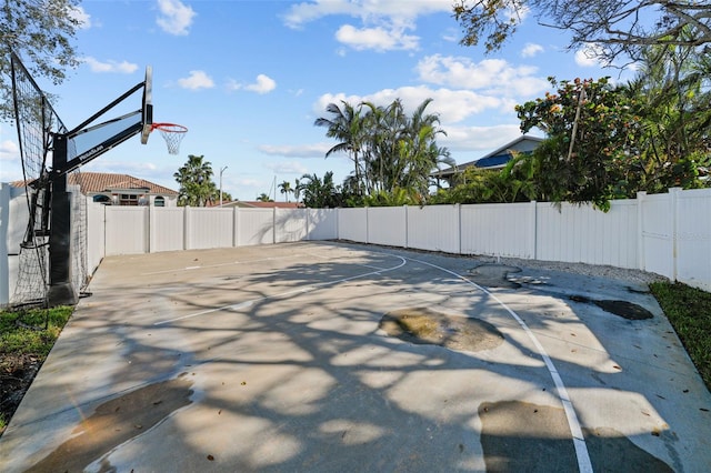 view of sport court with a fenced backyard and basketball court