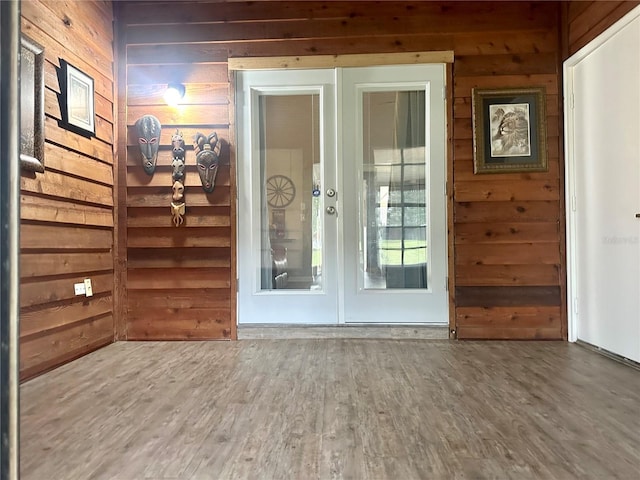 entryway featuring wood finished floors and wooden walls