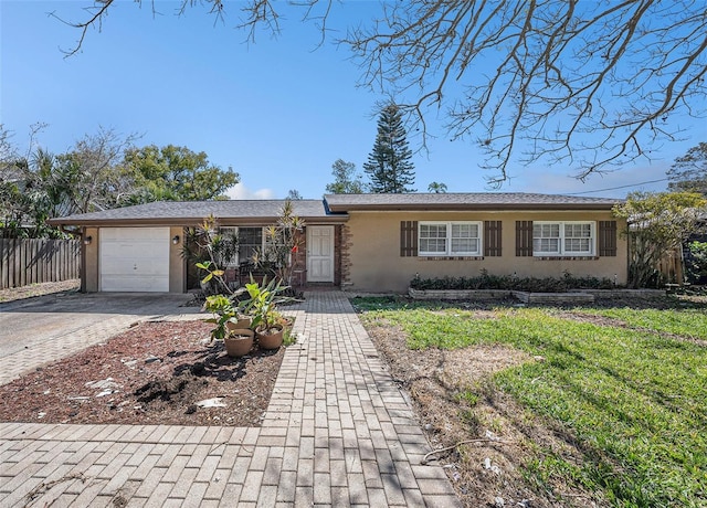 ranch-style house with a garage, driveway, fence, and stucco siding