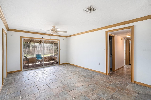 spare room with baseboards, visible vents, stone finish floor, crown molding, and a textured ceiling