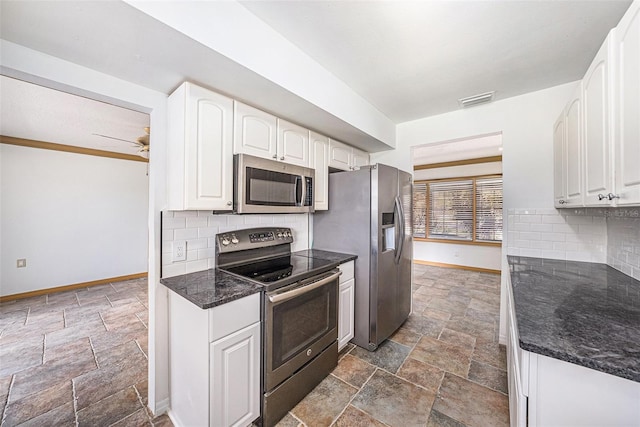 kitchen featuring visible vents, white cabinetry, baseboards, appliances with stainless steel finishes, and stone tile flooring