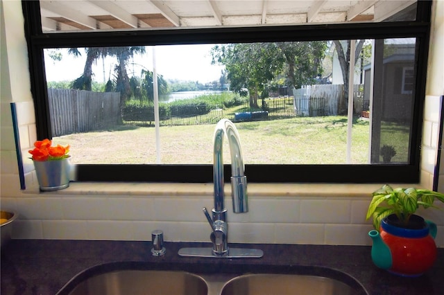 interior details featuring backsplash and a sink