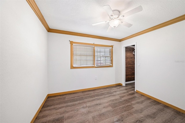 unfurnished room featuring crown molding, a textured ceiling, baseboards, and wood finished floors