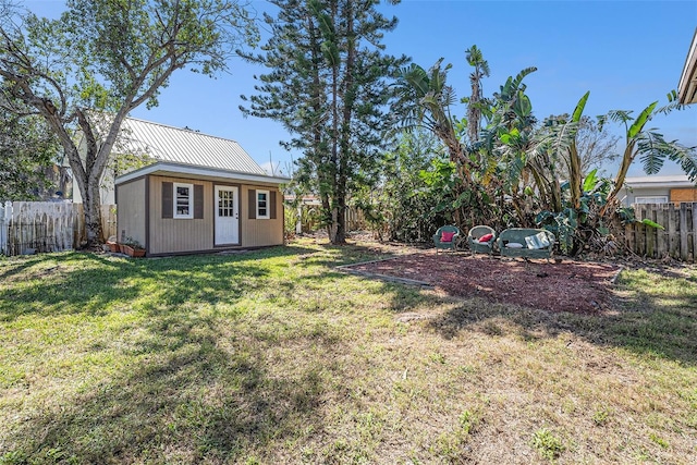 view of yard with a fenced backyard and an outdoor structure