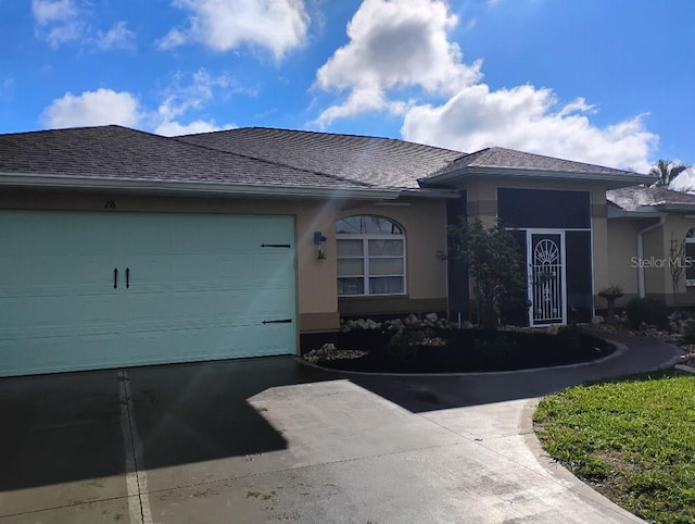 ranch-style home with a garage, roof with shingles, driveway, and stucco siding