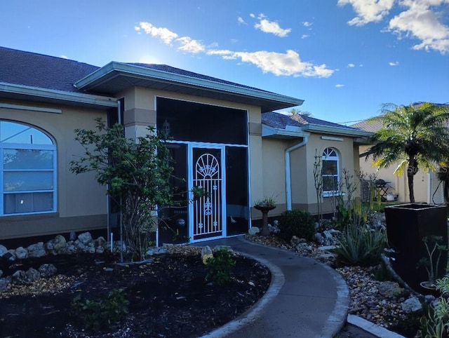 doorway to property with stucco siding