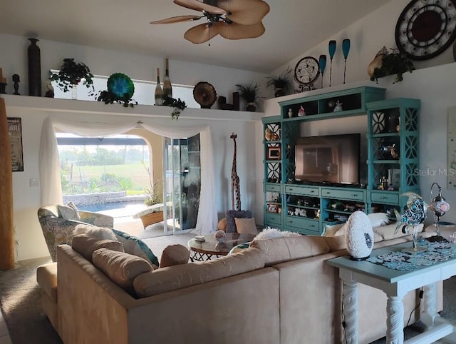 living area featuring vaulted ceiling and a ceiling fan