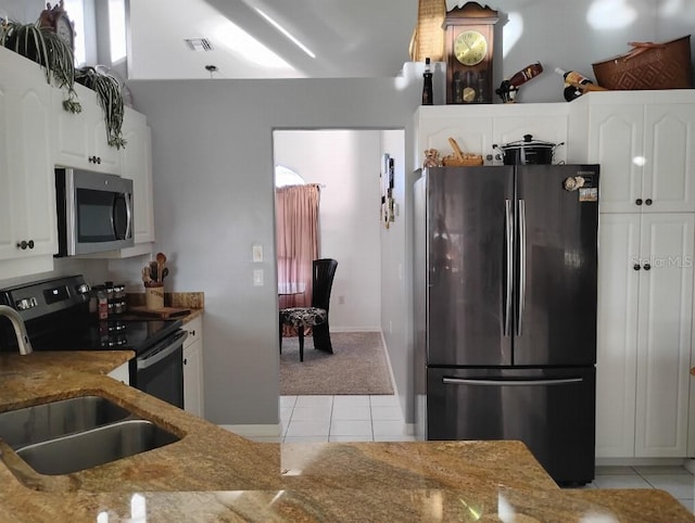 kitchen featuring light tile patterned floors, visible vents, appliances with stainless steel finishes, a sink, and light stone countertops