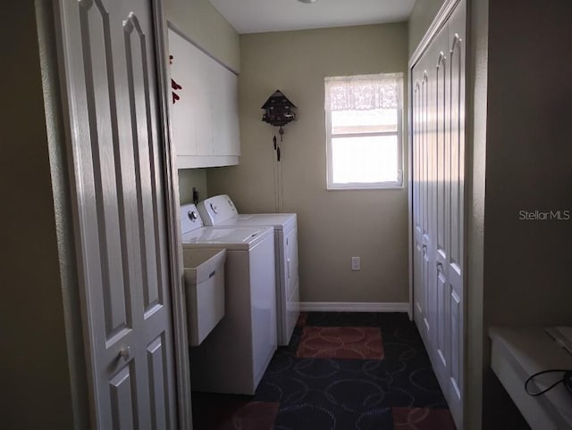 washroom with cabinet space, baseboards, and separate washer and dryer