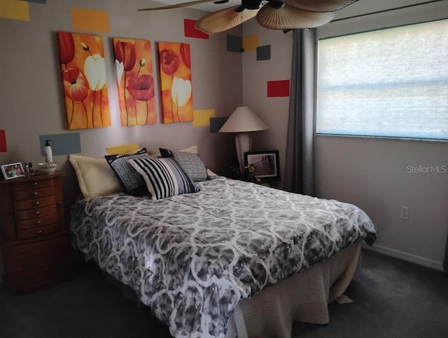 bedroom with a ceiling fan, carpet flooring, and baseboards