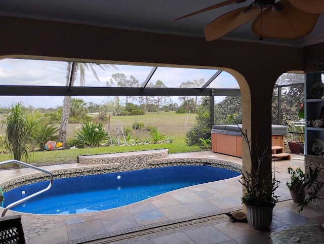 view of pool with a patio, a ceiling fan, glass enclosure, and a hot tub