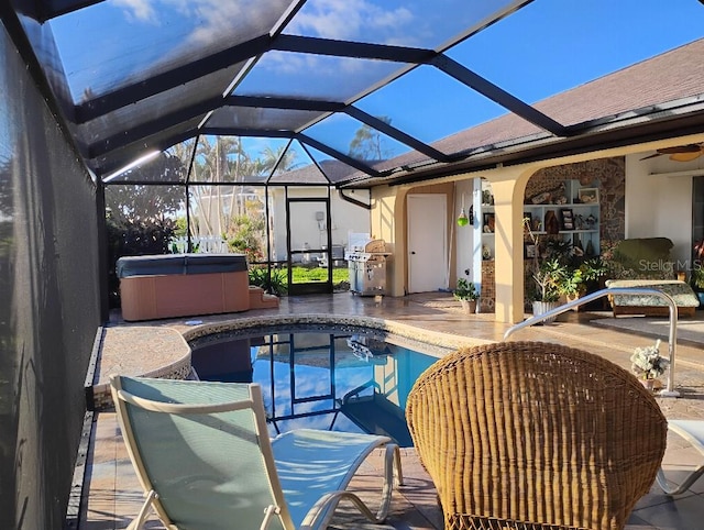 outdoor pool with area for grilling, glass enclosure, a patio area, and a hot tub