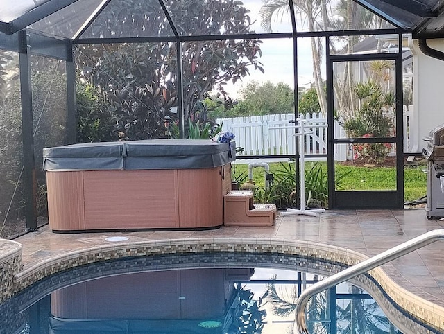 outdoor pool with a patio, a lanai, fence, and a hot tub