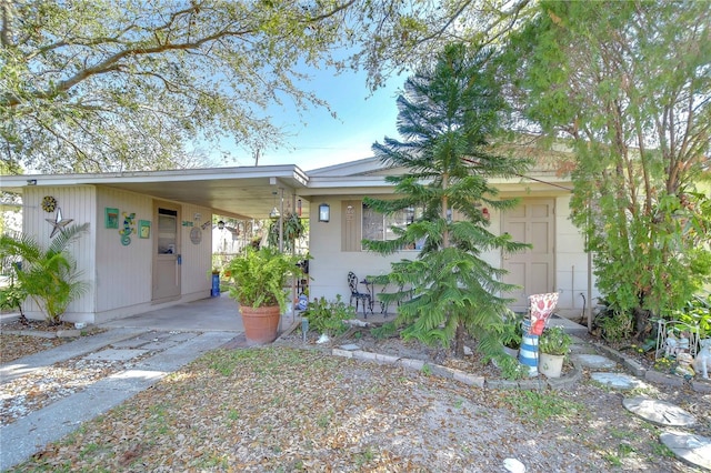 ranch-style home with a carport and driveway