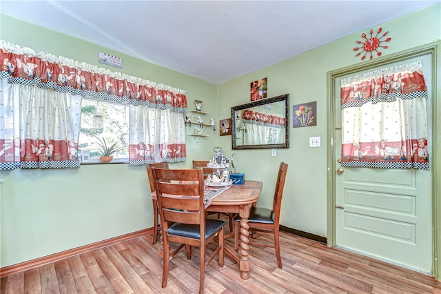 dining space featuring wood finished floors and baseboards